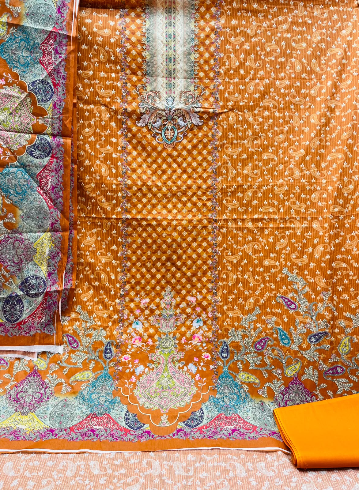 Premium Digital Printed Unstitched Three Piece with elegant floral and ethnic prints, soft breathable fabric, matching printed orna, and matching bottom fabric. Perfect for casual wear, office, festivals, and special occasions.